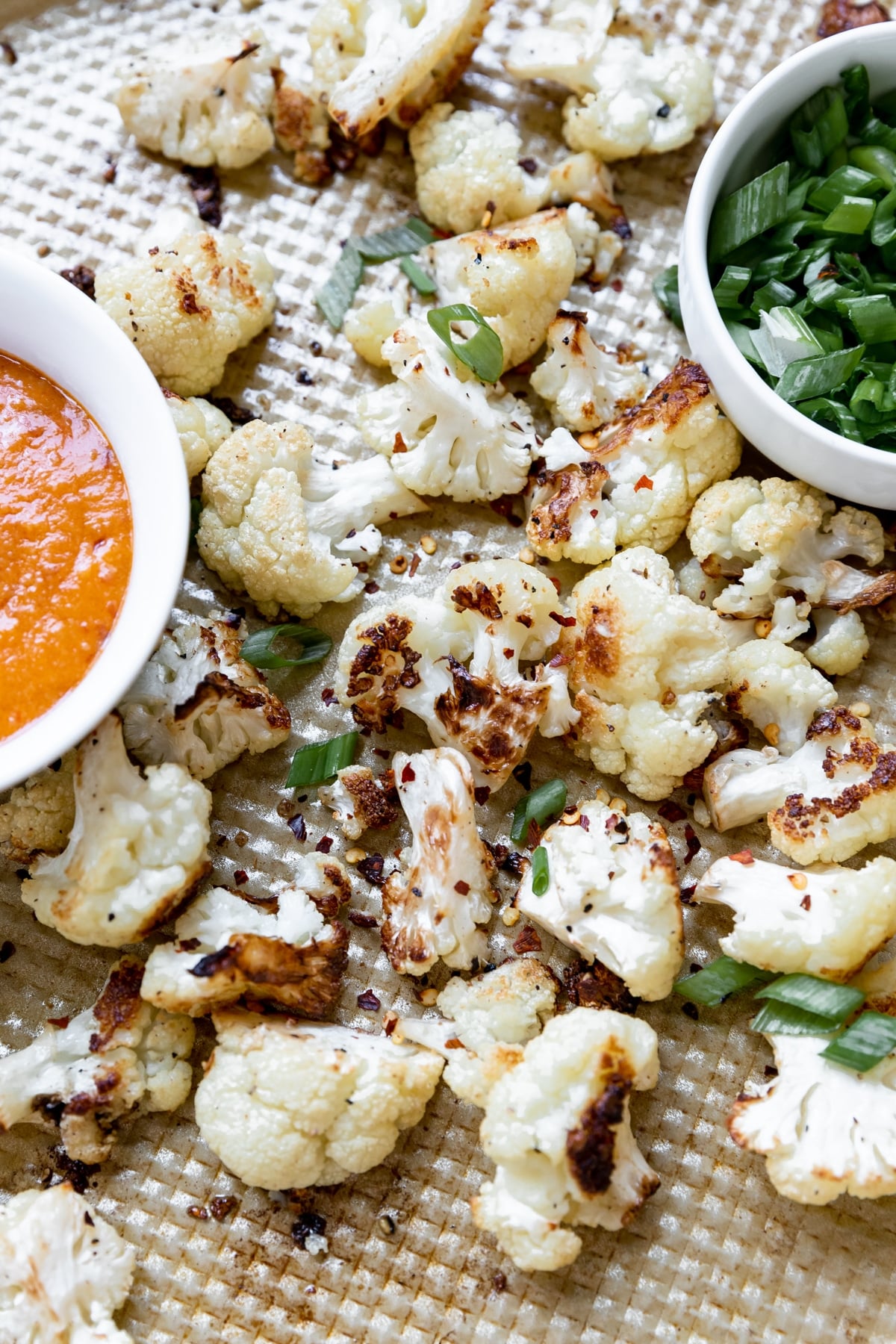 roasted cauliflower florets on a gold baking sheet