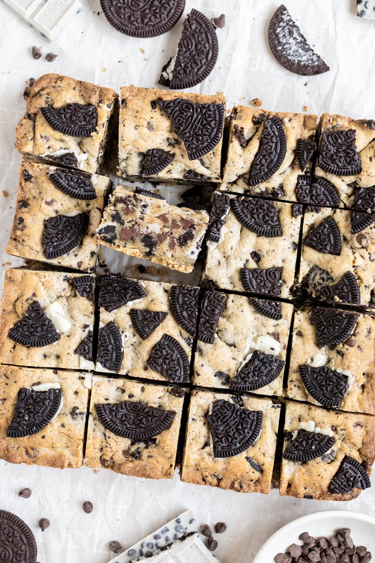 cookies and cream bars on a piece of parchment paper, cut into square bars