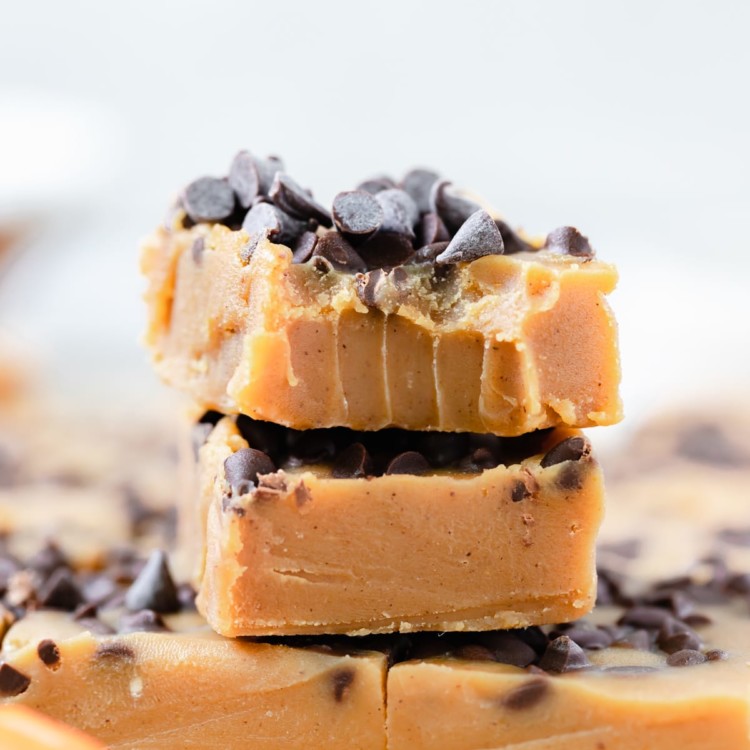 pumpkin fudge bars stacked on top of each other topped with mini chocolate chips