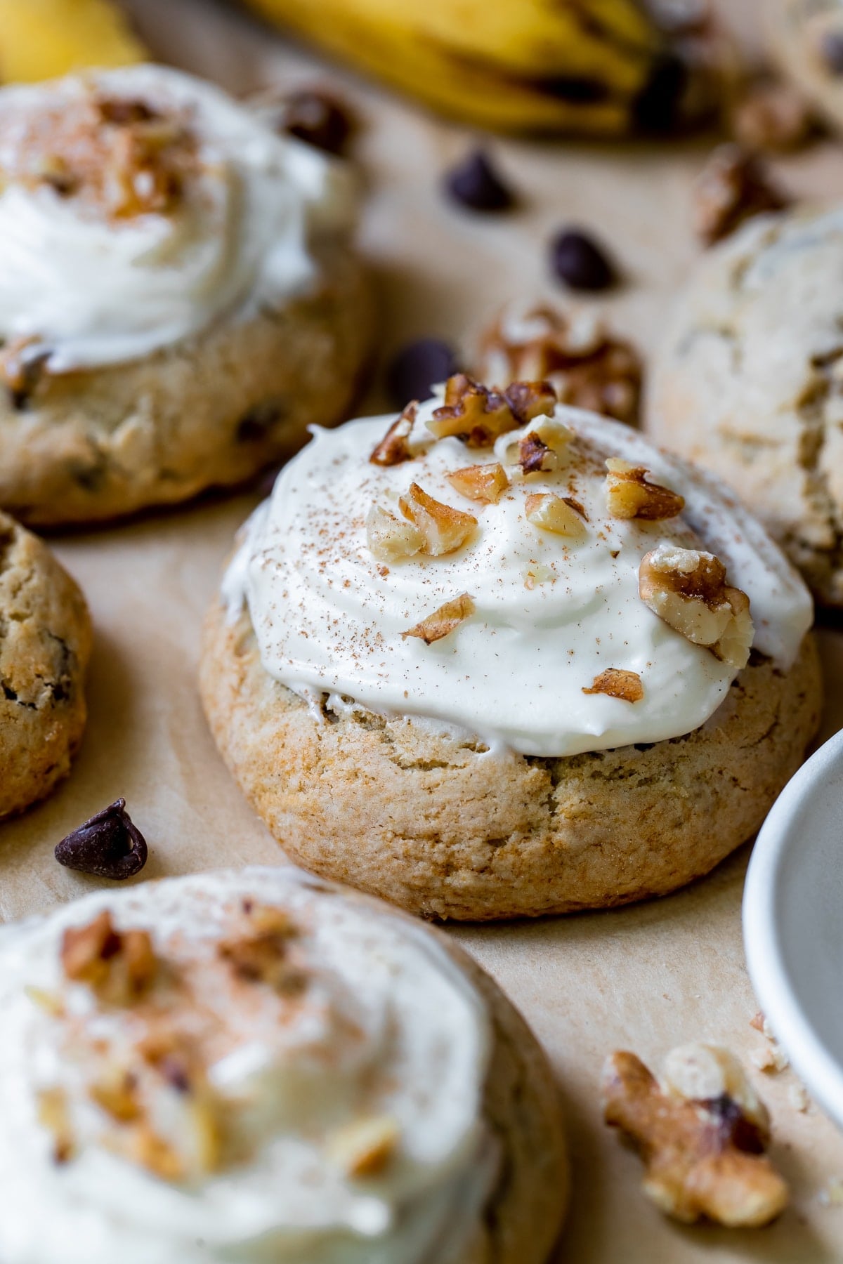 cookies made with bananas on parchment paper topped with walnuts and cinnamon