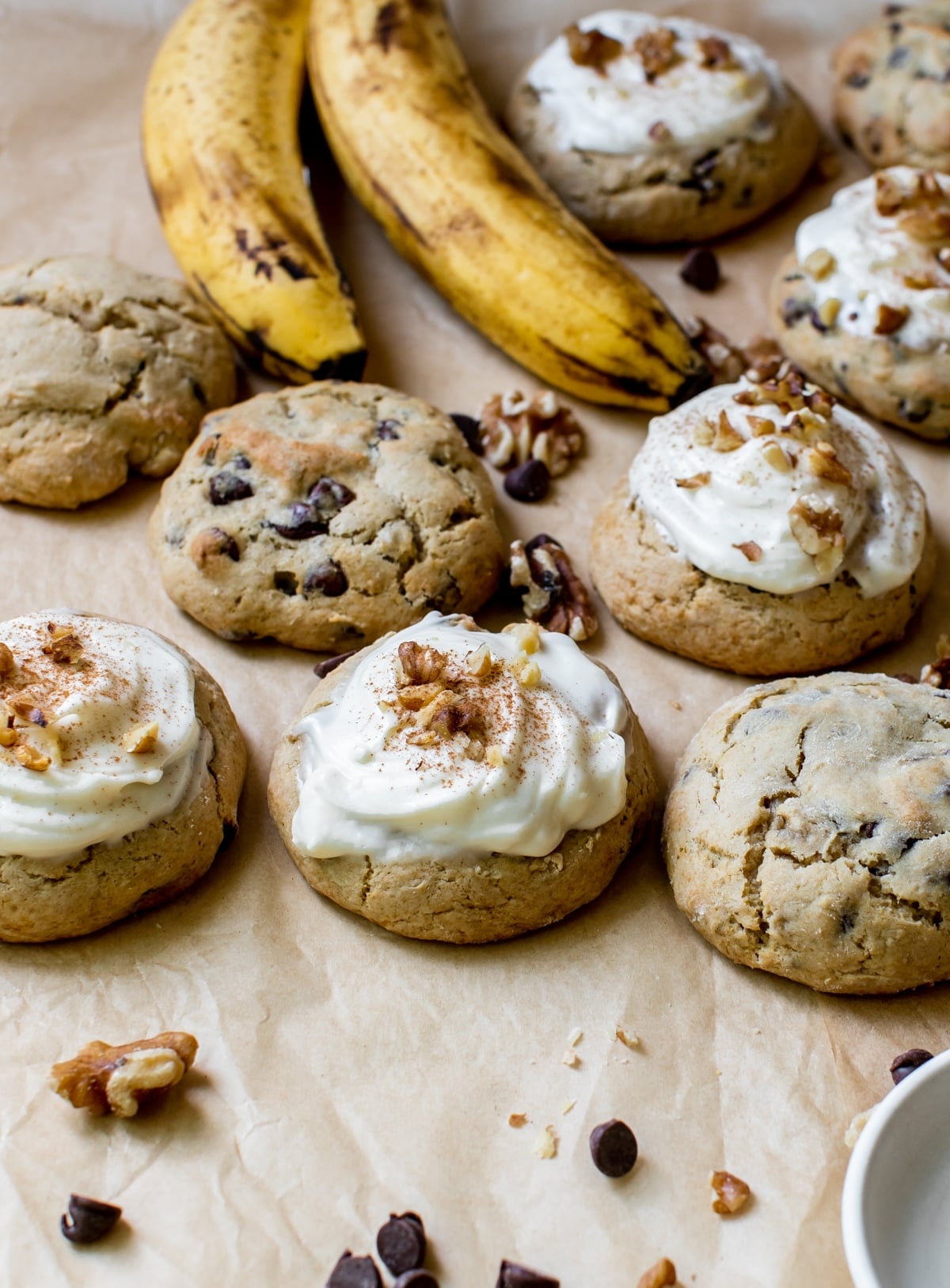 cookies made with bananas on parchment paper topped with walnuts and cinnamon