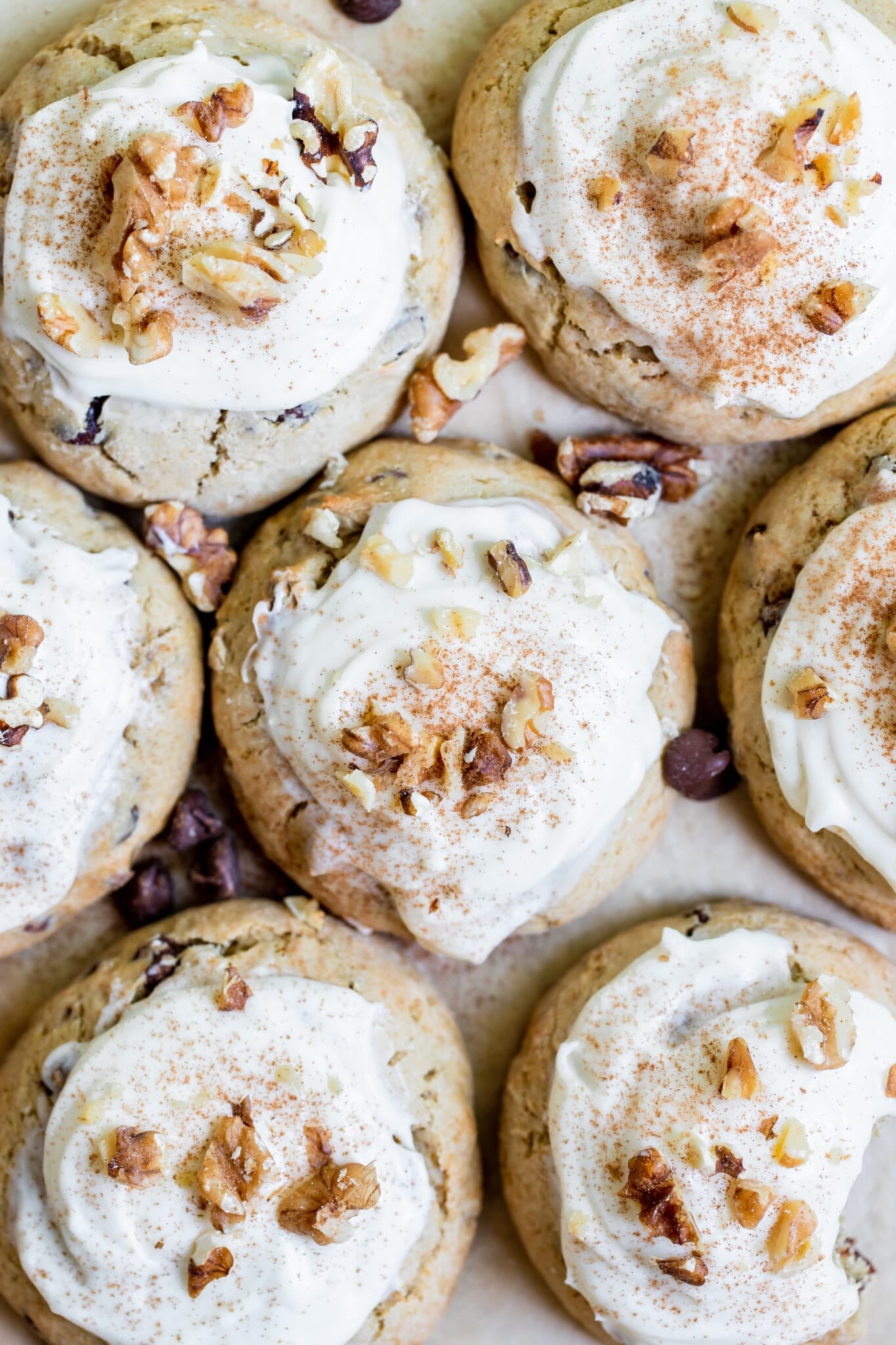 cookies made with bananas on parchment paper topped with walnuts and cinnamon