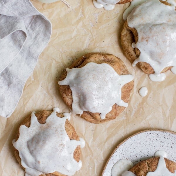 a chai cookies on parchment paper topped with vanilla bean glaze