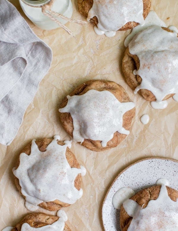 a chai cookies on parchment paper topped with vanilla bean glaze