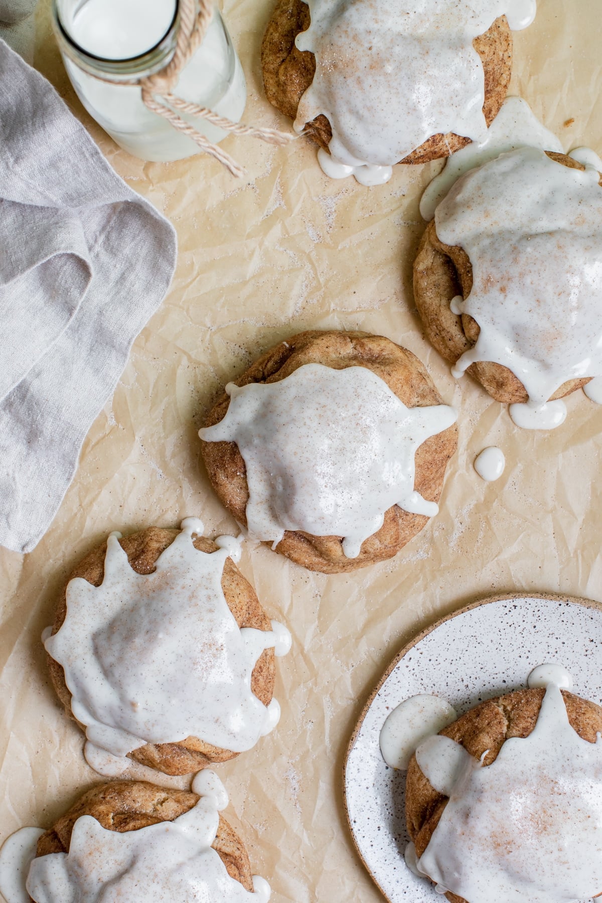 a chai cookies on parchment paper topped with vanilla bean glaze
