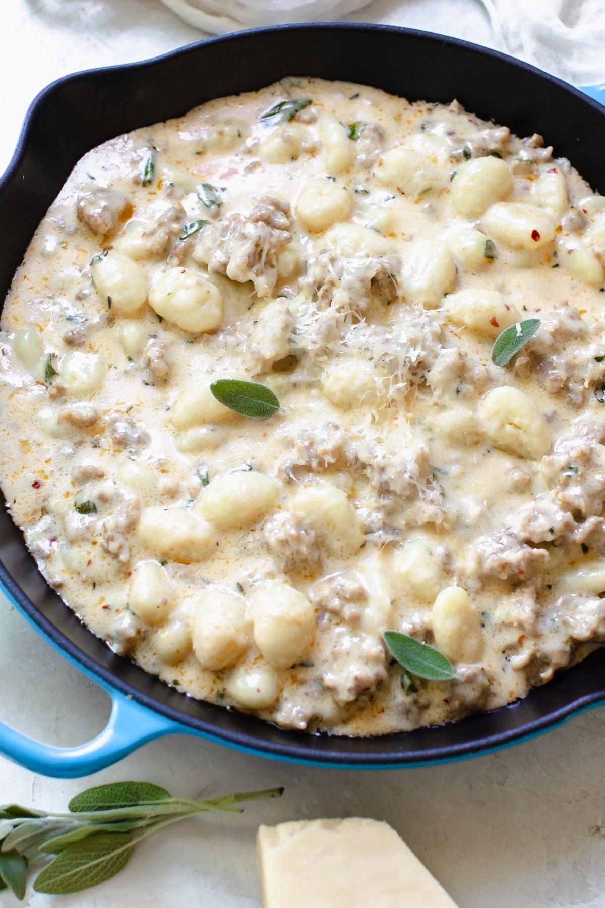 This Creamy Gnocchi Recipe is cozy, comforting and just so delicious. Made with a rich and creamy sauce, spicy Italian sausage, Parmesan cheese and fresh sage. It's a quick and easy weeknight dinner you'll love! #creamygnocchi #gnocchirecipes #easygnocchi #pastarecipes #gnocchidinner #creamypasta #italiansausage #krollskorner #weeknightdinner