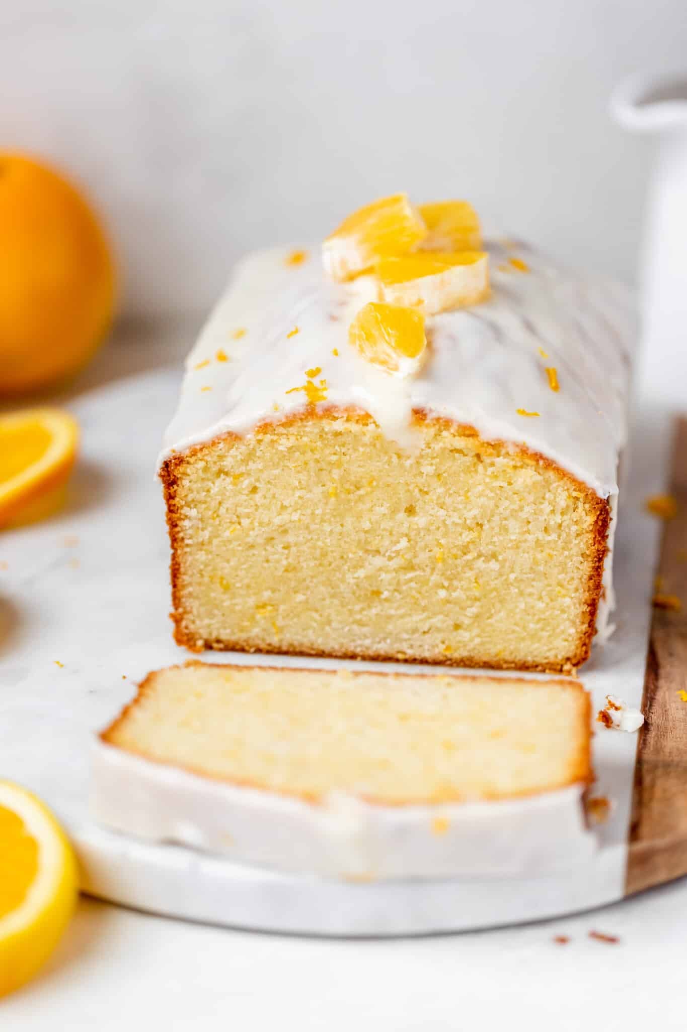pound cake with a glaze on top on a marble board