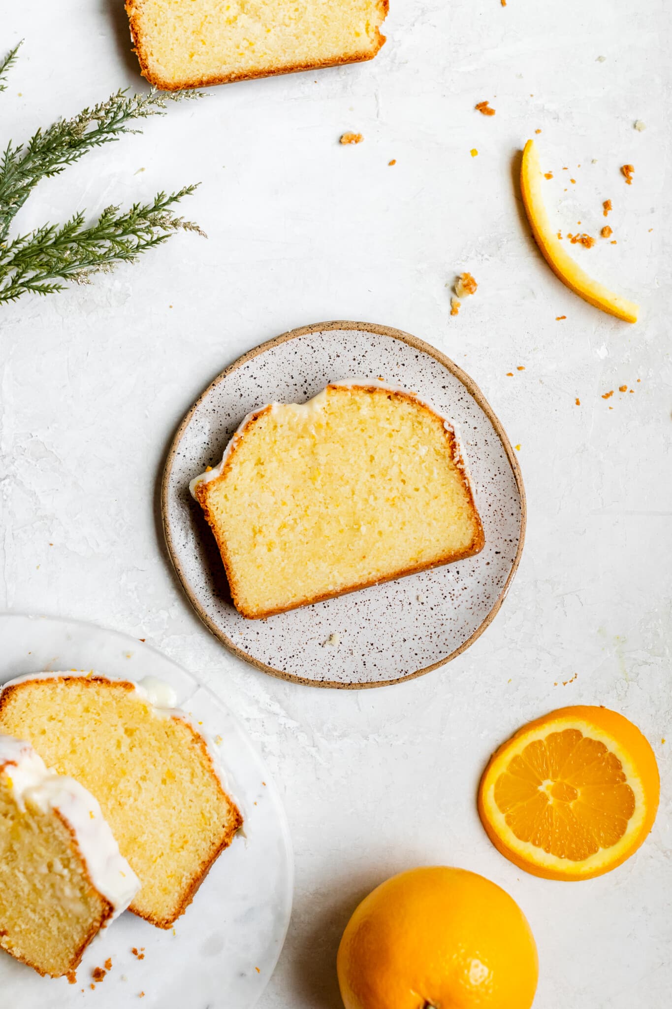a slice of pound cake on a white specked plate