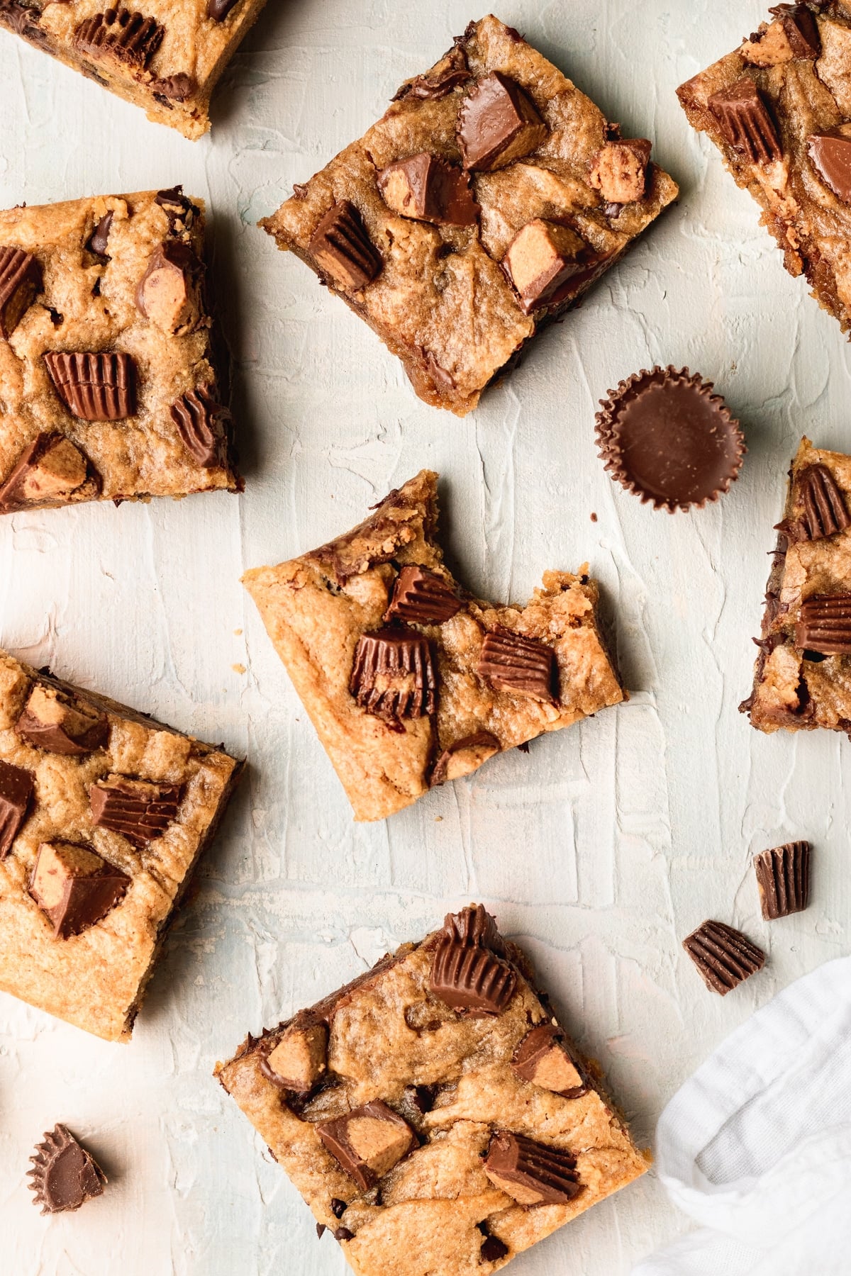 a bite taken out of a blondie with peanut butter cups on top