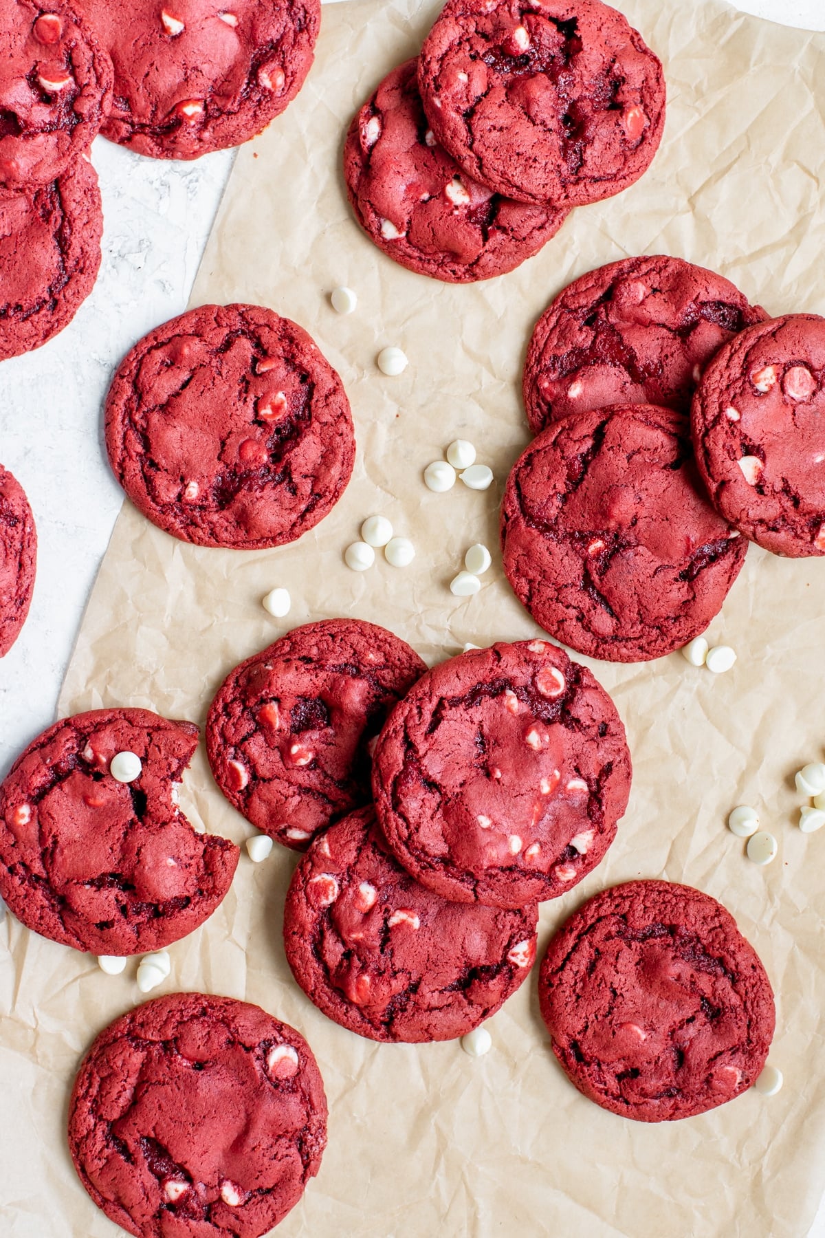 a fresh batch of cookies with white chocolate chips on parchment paper