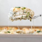 a spatula serving a slice of lasagna out of the pan