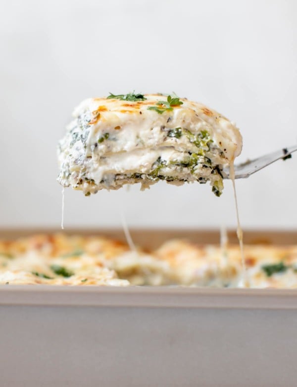 a spatula serving a slice of lasagna out of the pan