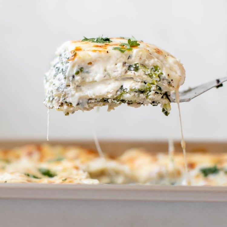 a spatula serving a slice of lasagna out of the pan