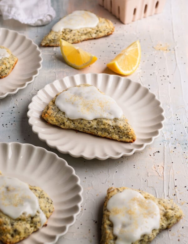 scones on white plates topped with glaze