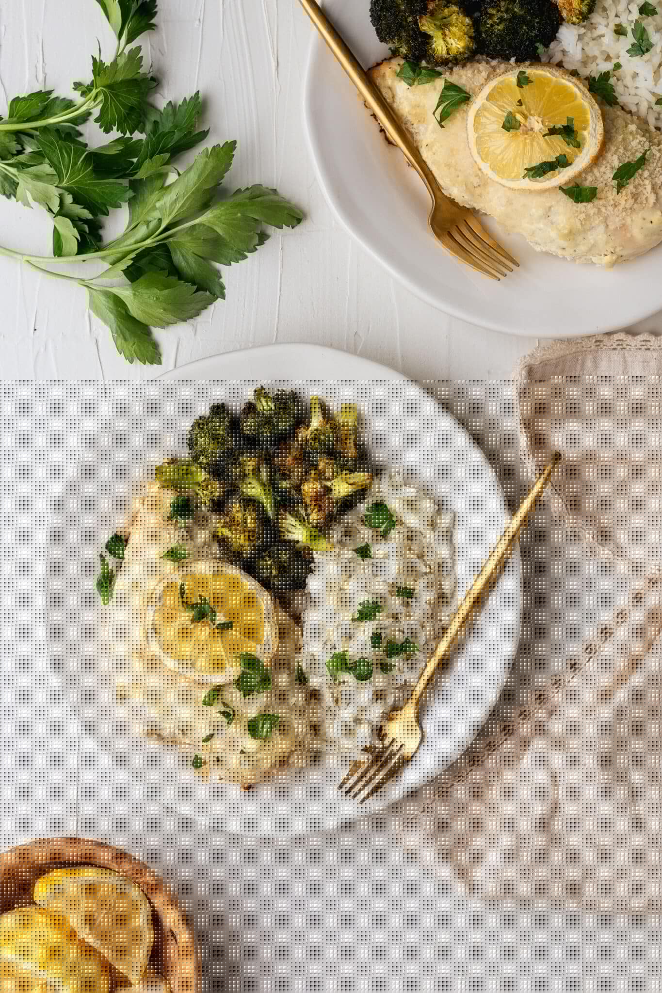 lemon baked chicken on a white plate with roasted broccoli and white rice