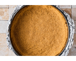 Pie pan with graham cracker pressed into the rim to make a crust, with the outside lined in foil.