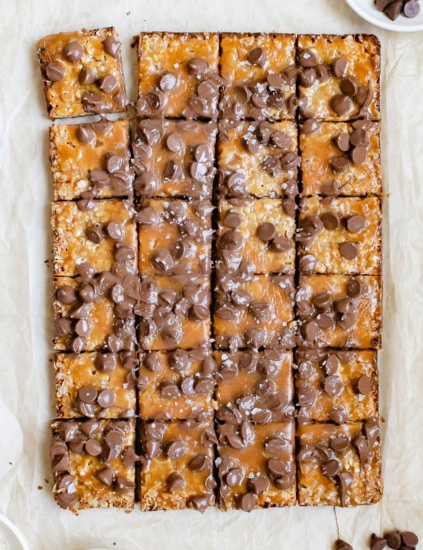 freshly baked caramel bar topped with chocolate chips and flaky sea salt