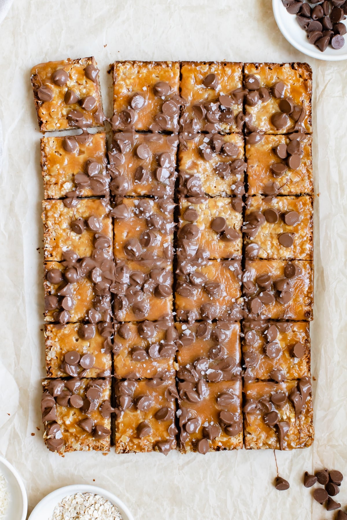 freshly baked caramel bar topped with chocolate chips and flaky sea salt
