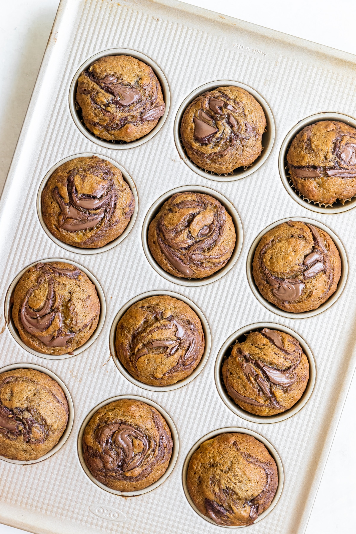 baked muffins with Nutella swirled on the tops