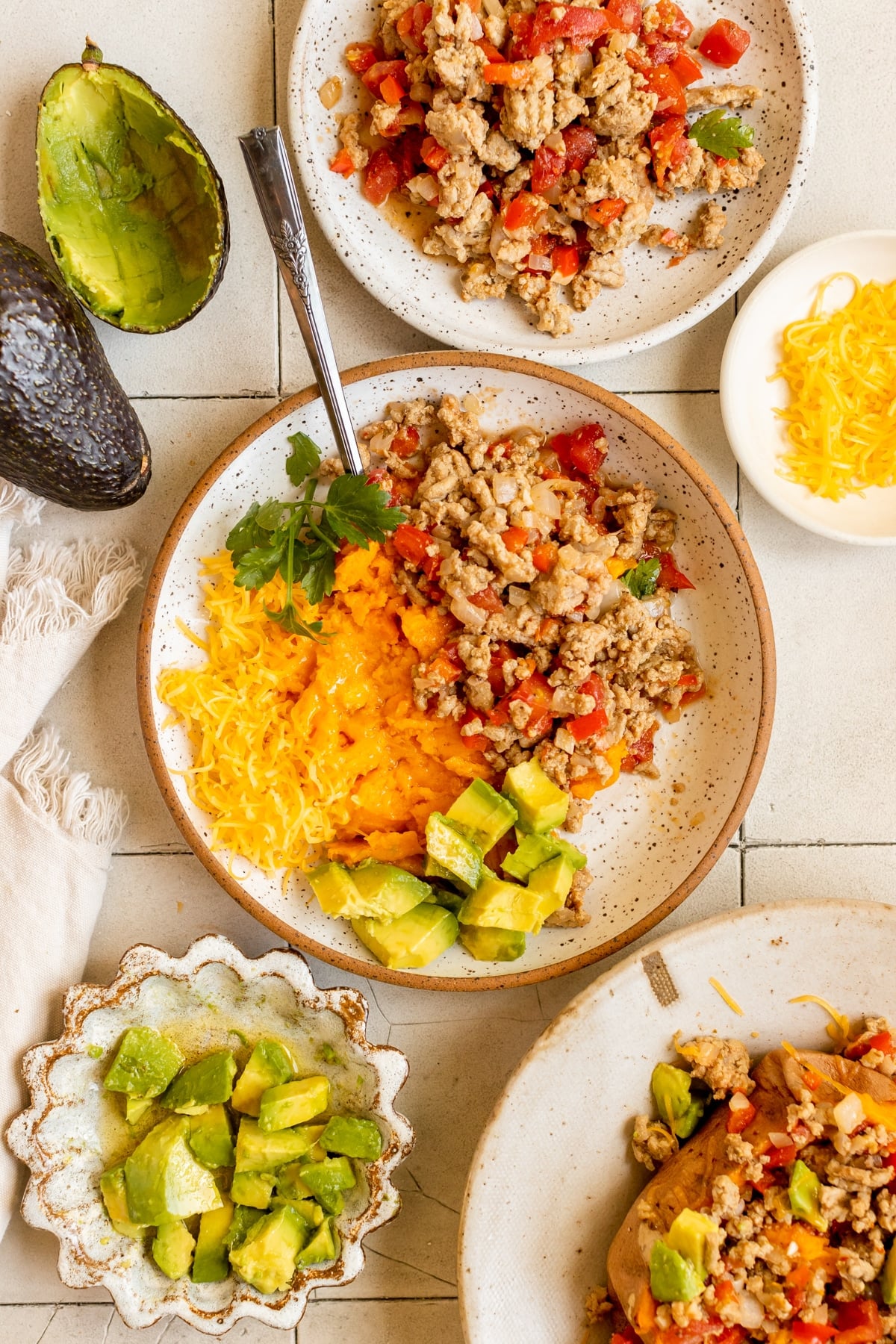 a ground turkey dinner bowl filled with sweet potato, ground turkey and avocado
