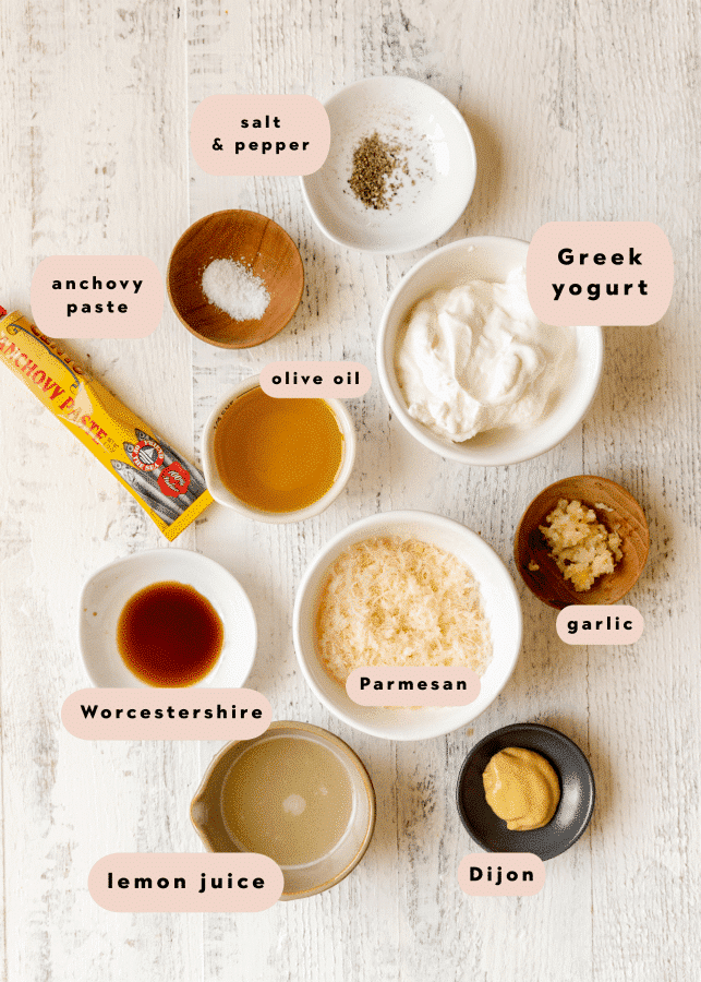 ingredients to make a homemade salad dressing in small glass dishes. 