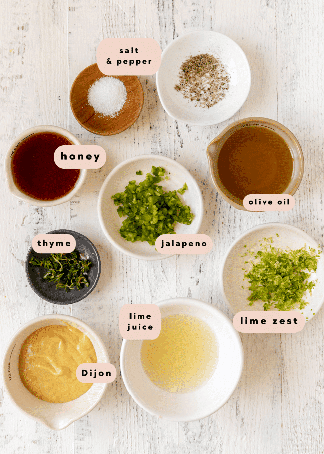 ingredients to make a homemade salad dressing in small glass dishes. 