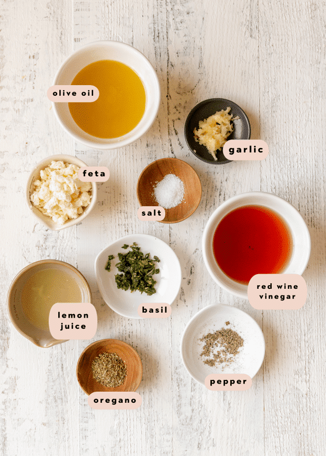 ingredients to make a homemade salad dressing in small glass dishes. 