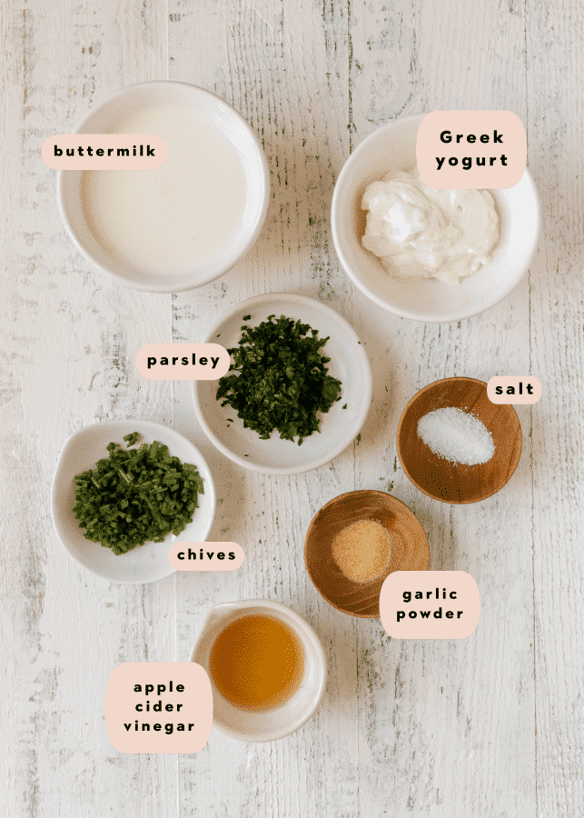 ingredients to make a homemade salad dressing in small glass dishes. 