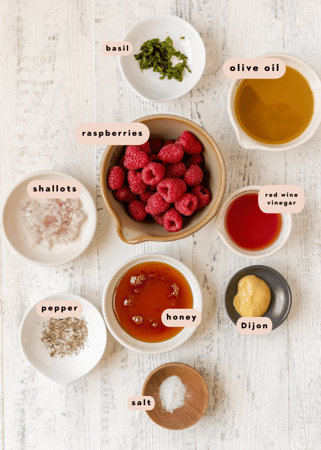 ingredients to make a homemade salad dressing in small glass dishes. 