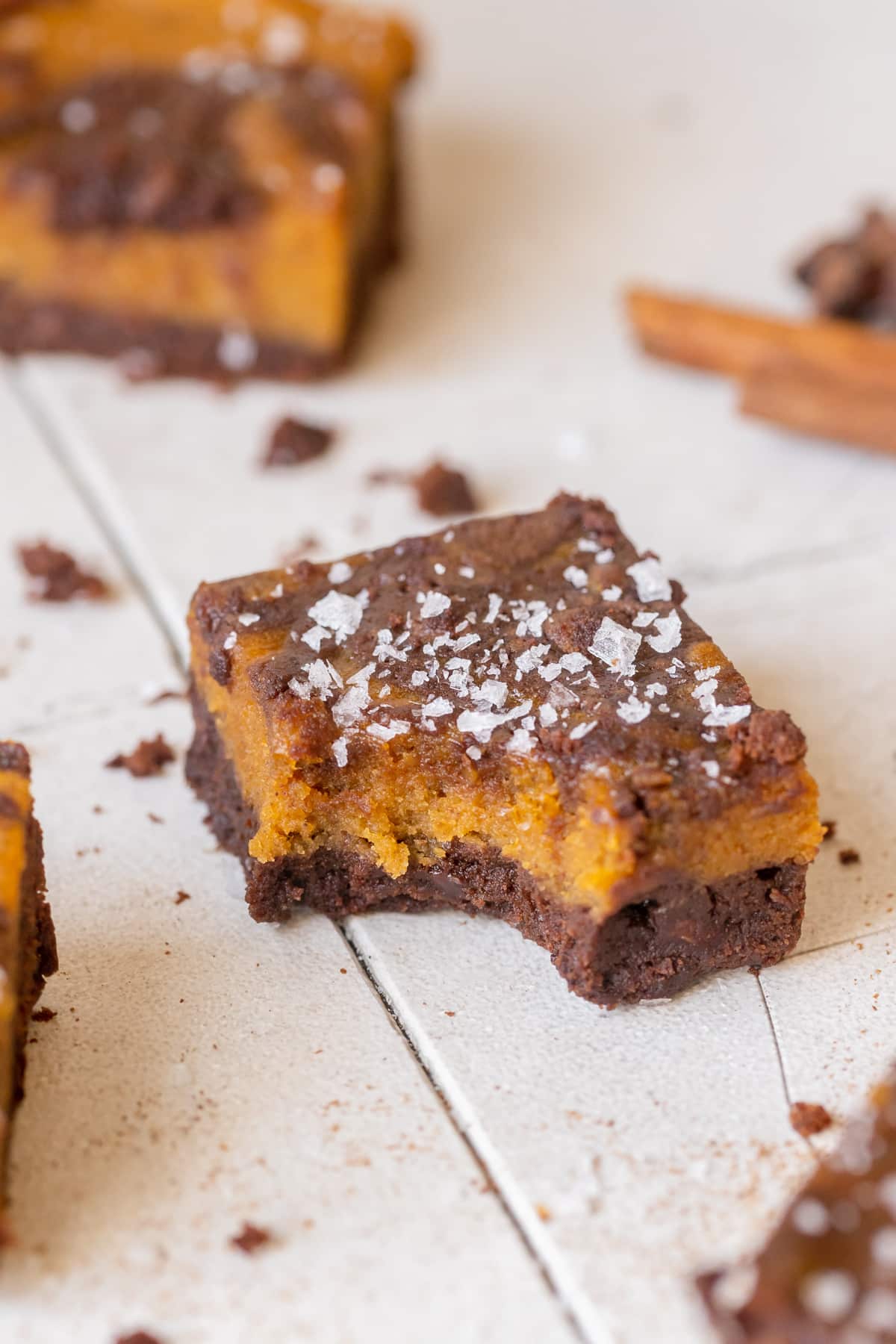 a brownie with a bite taken out of it topped with flaky sea salt. 
