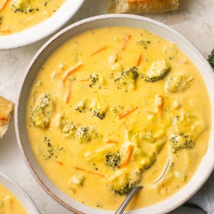 soup in a white soup bowl with bread on the side.