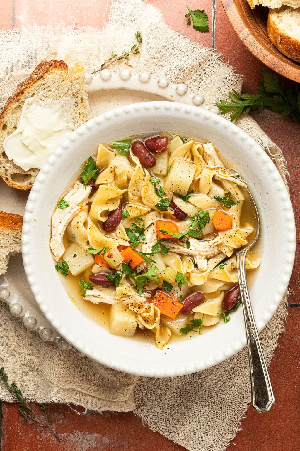 chicken noodle soup in bowl with spoon