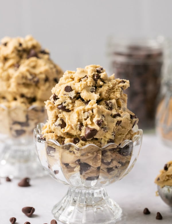 cookie dough with chocolate chips in a glass bowl.