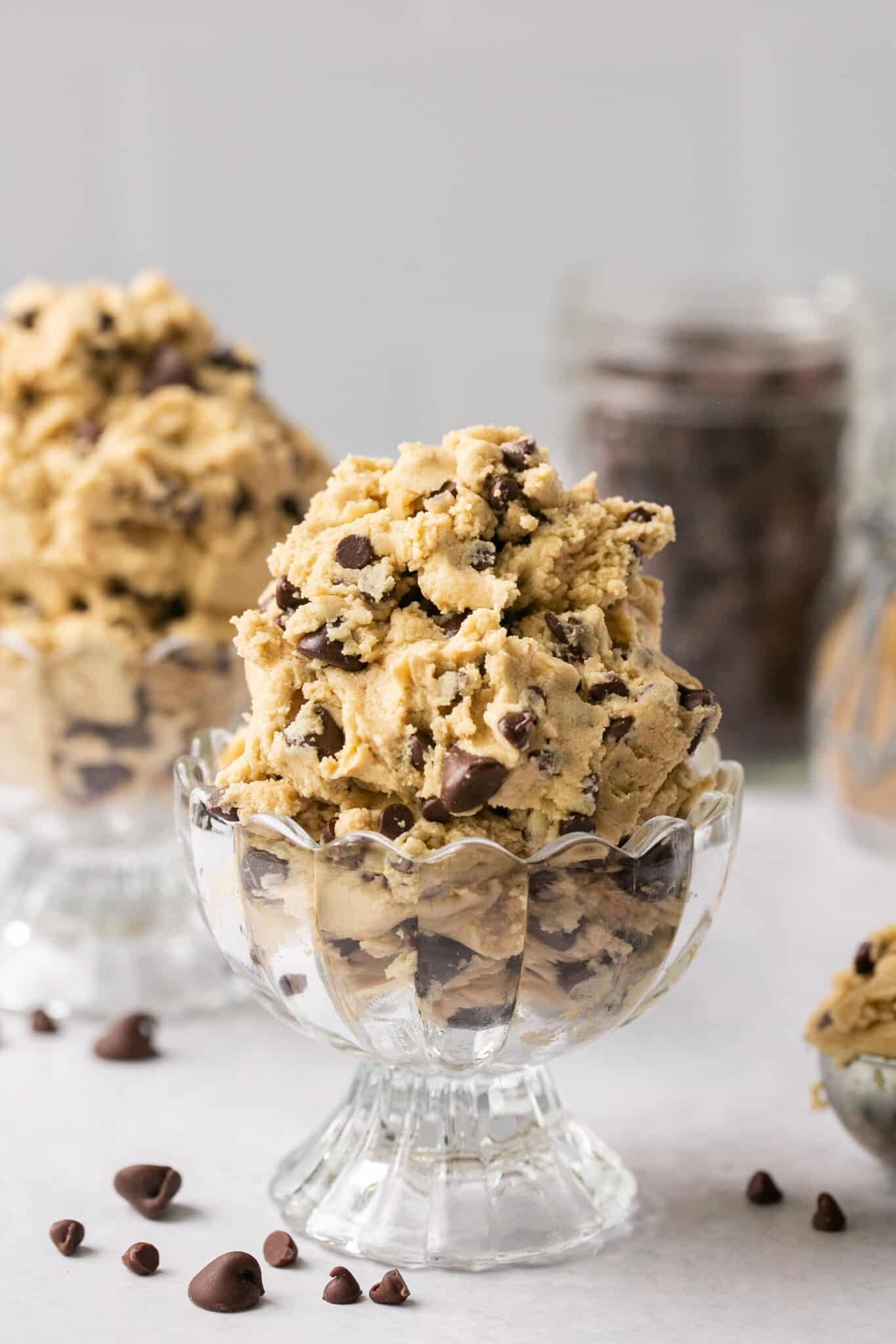 cookie dough with chocolate chips in a glass bowl.
