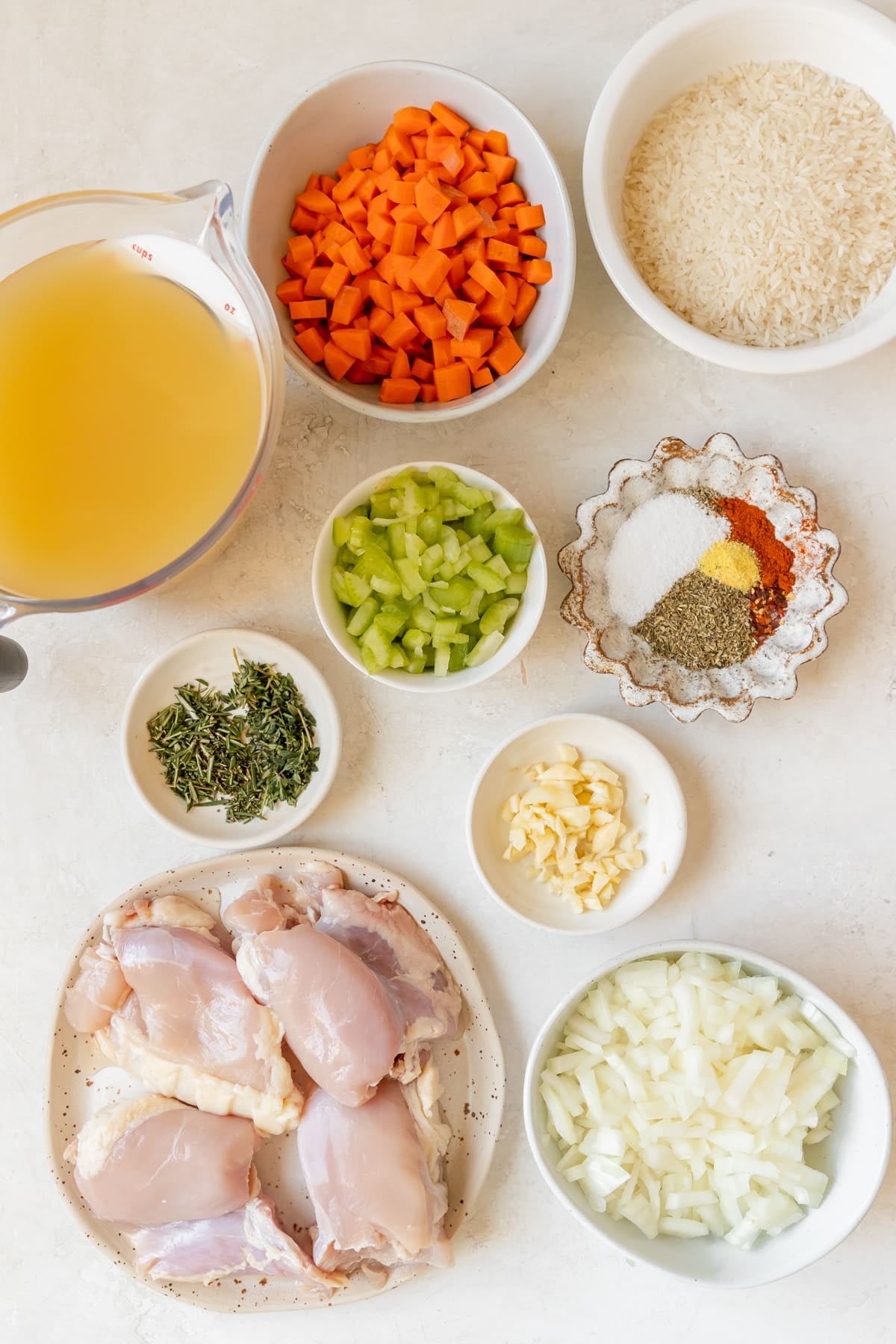 ingredients to make a soup in small white bowls.