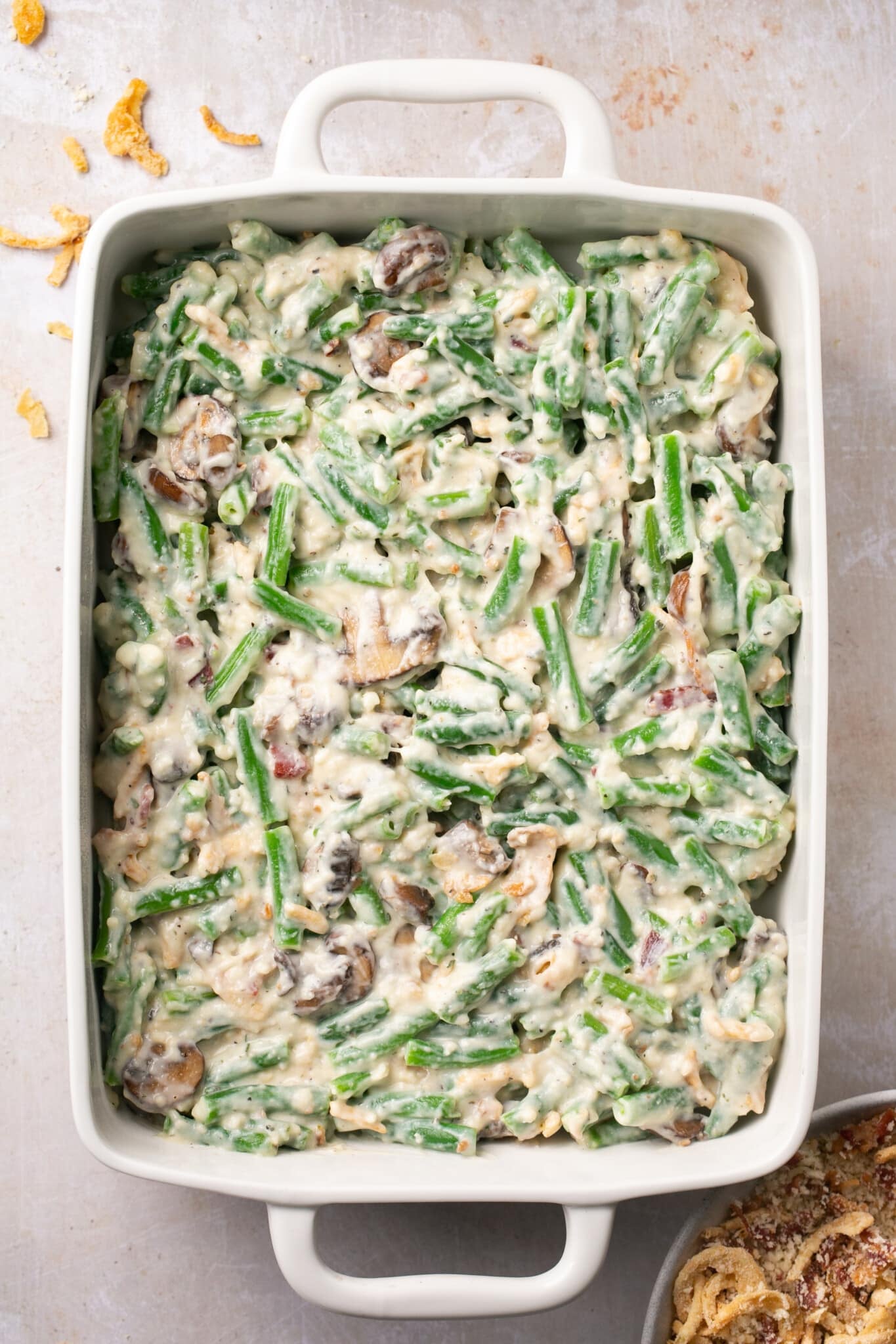 a 9x13 casserole dish filled with a green bean casserole.
