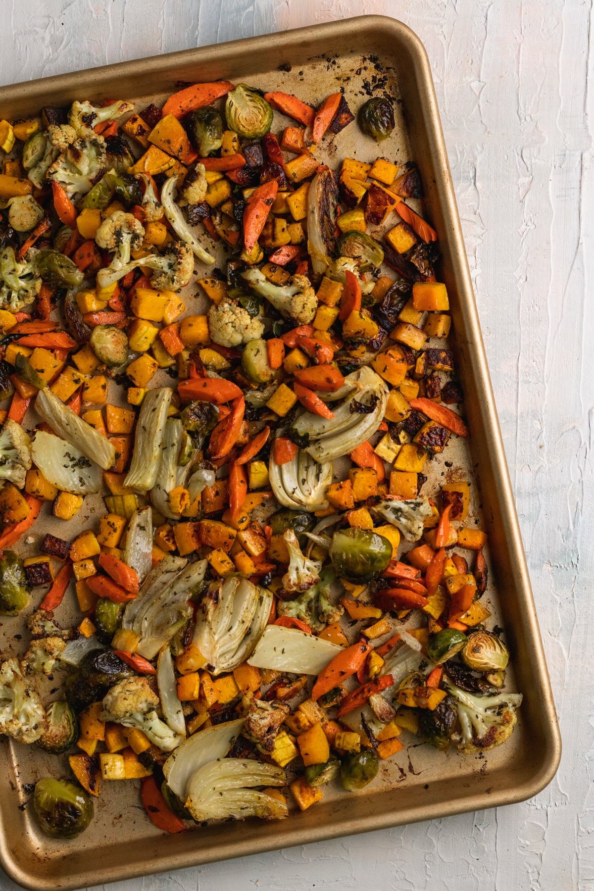 roasted veggies on a gold sheet pan.