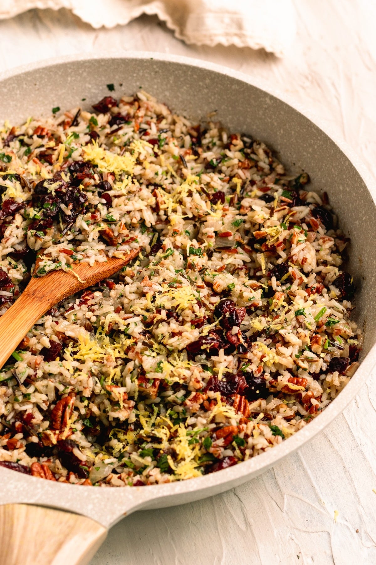 pilaf in a skillet garnished with lemon zest.