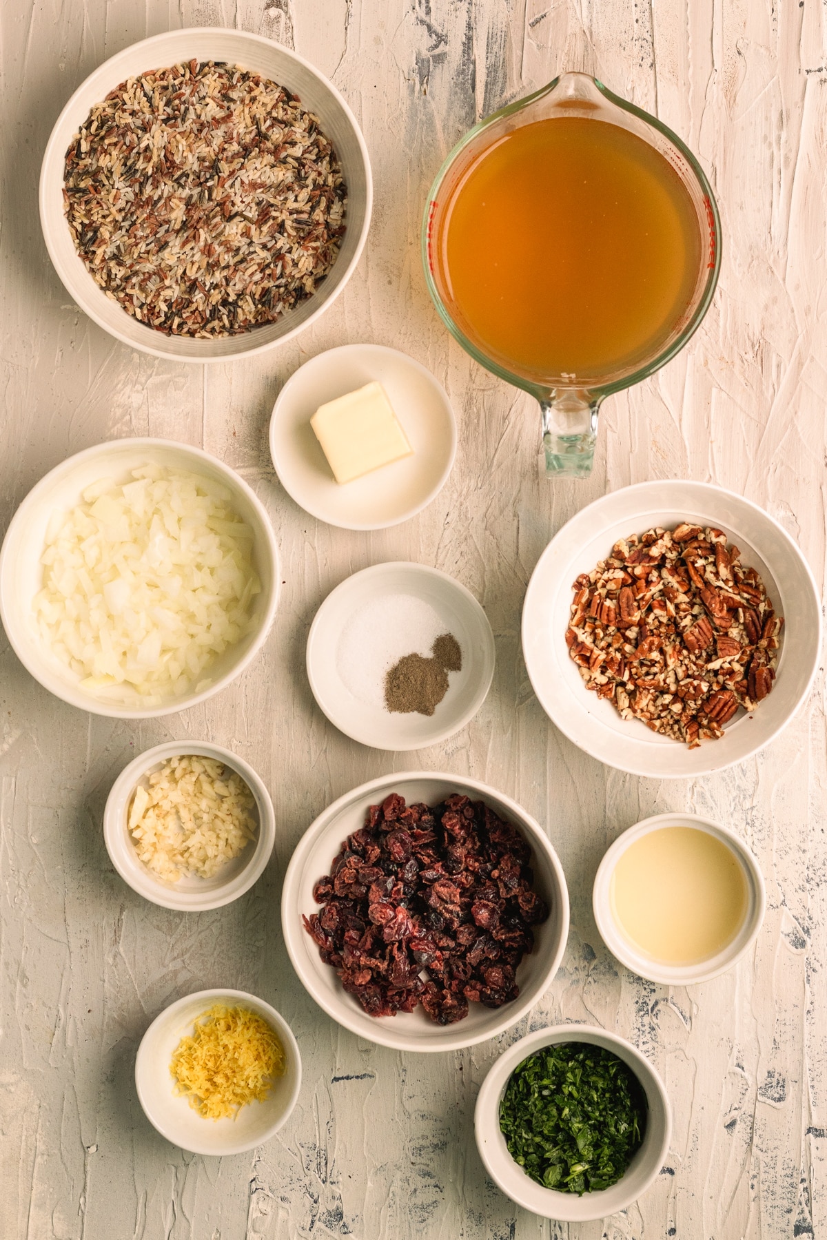 ingredients to make wild rice in small white bowls.