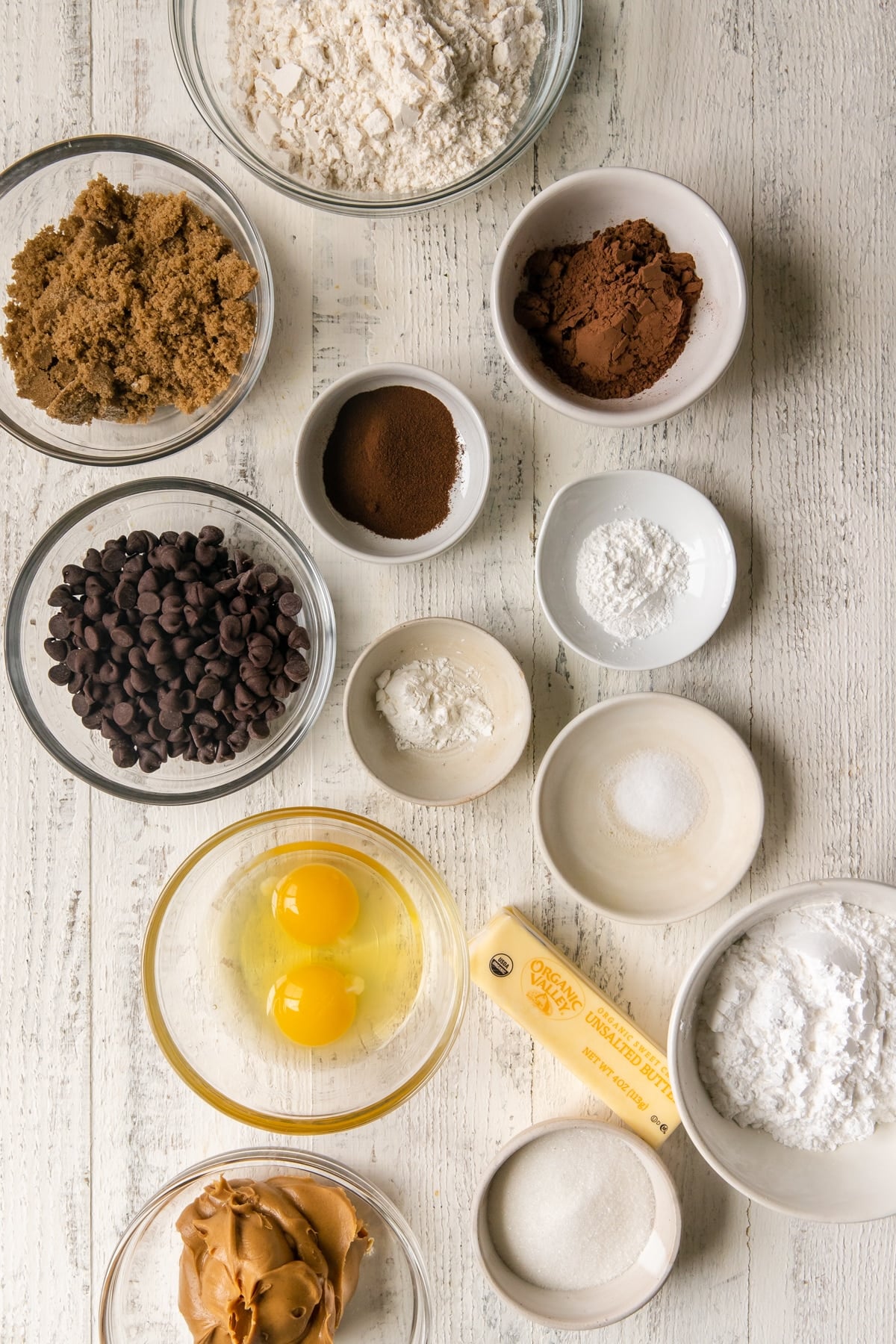 ingredients to make cookies in glass bowls 