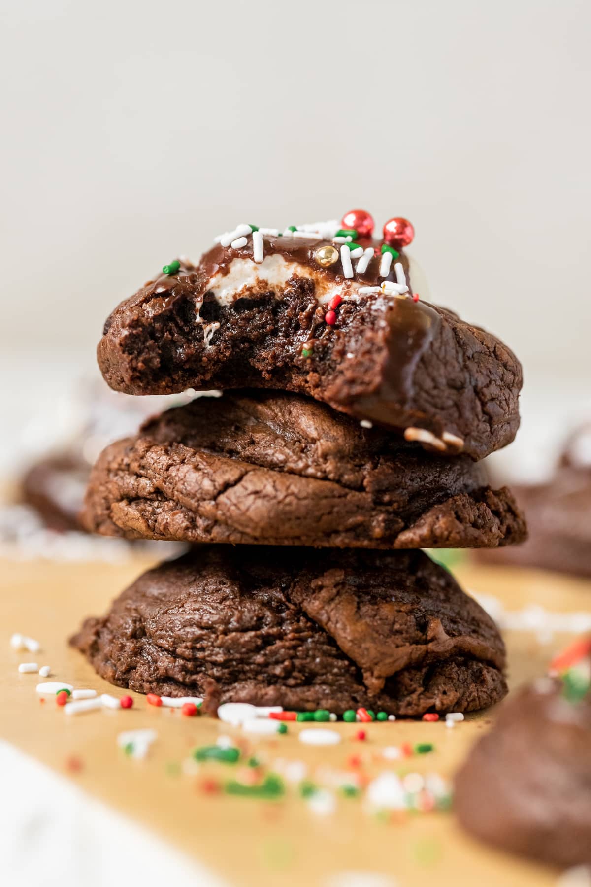 a stack of cookies with a bite taken out of the cookie on top.