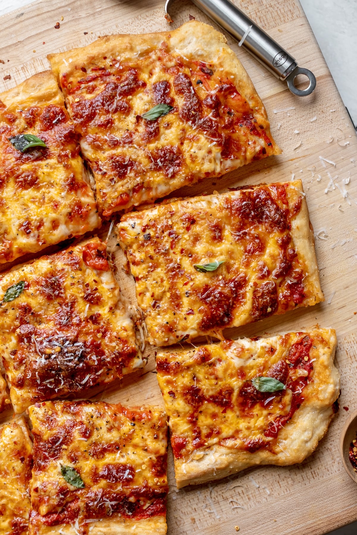 a close up image of pizza garnished with parmesan cheese.