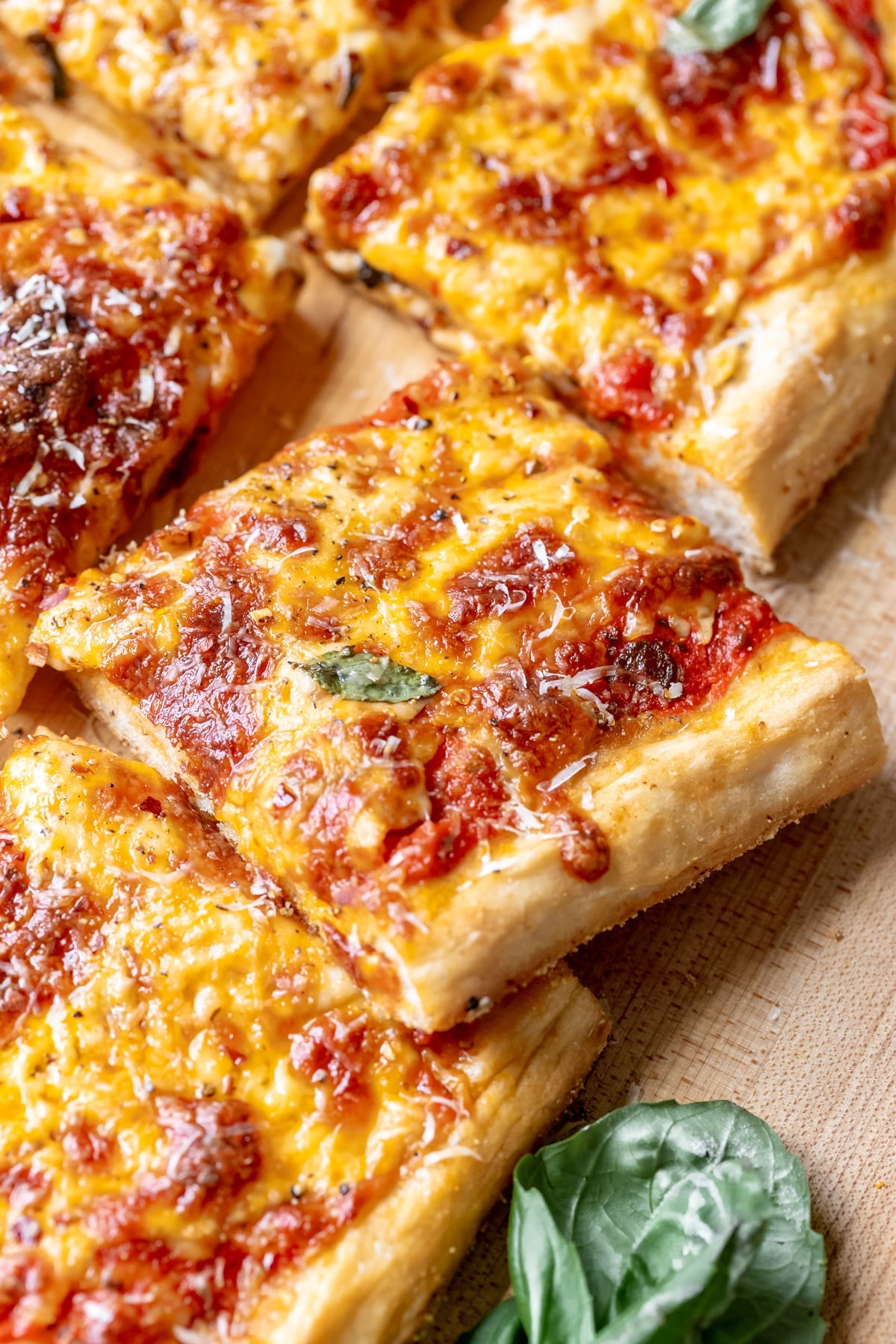 a close up image of pizza garnished with parmesan cheese.
