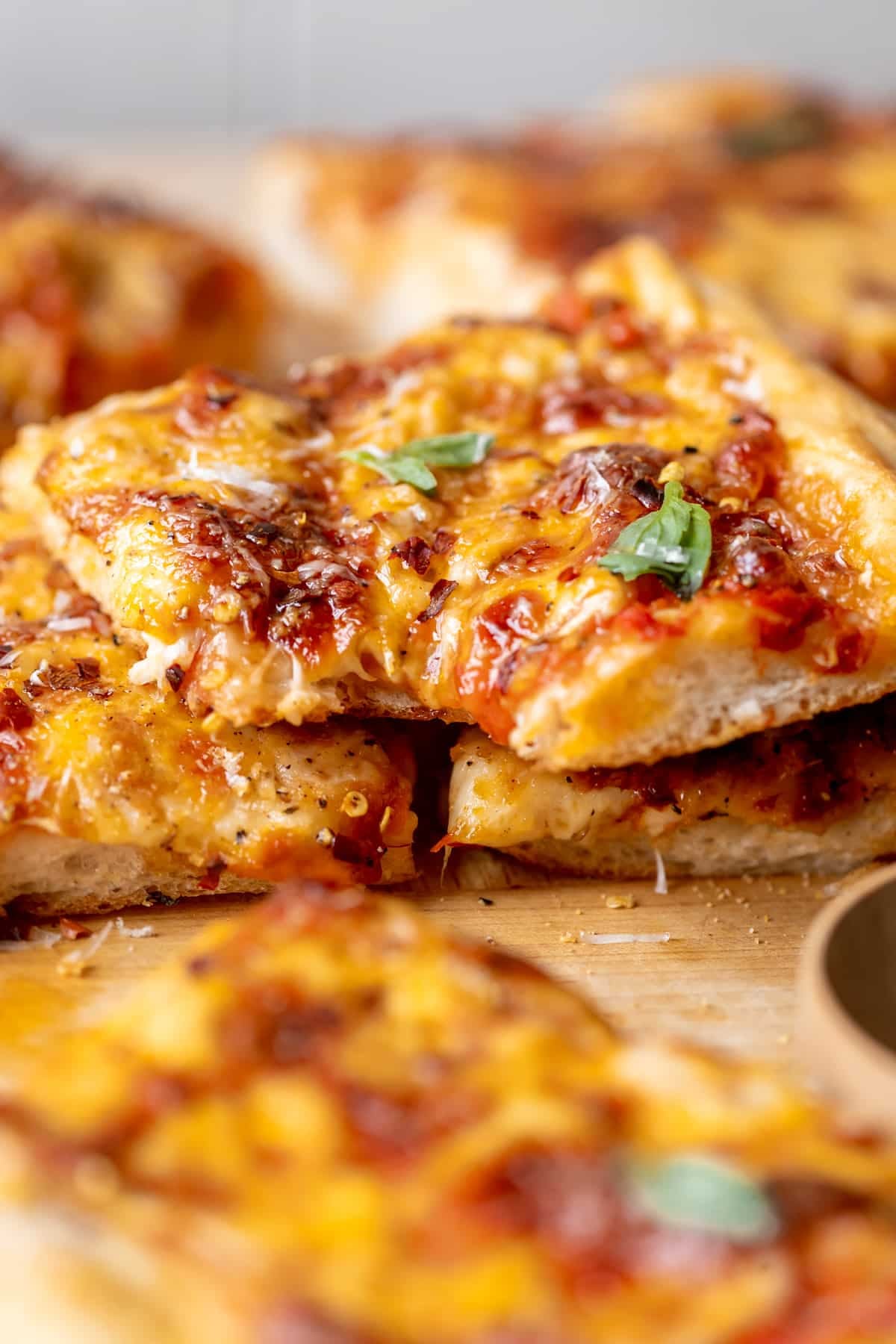 a close up image of pizza garnished with parmesan cheese.