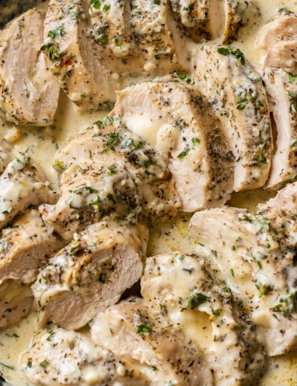 slices of chicken breast in a mozzarella cream sauce topped with herbs