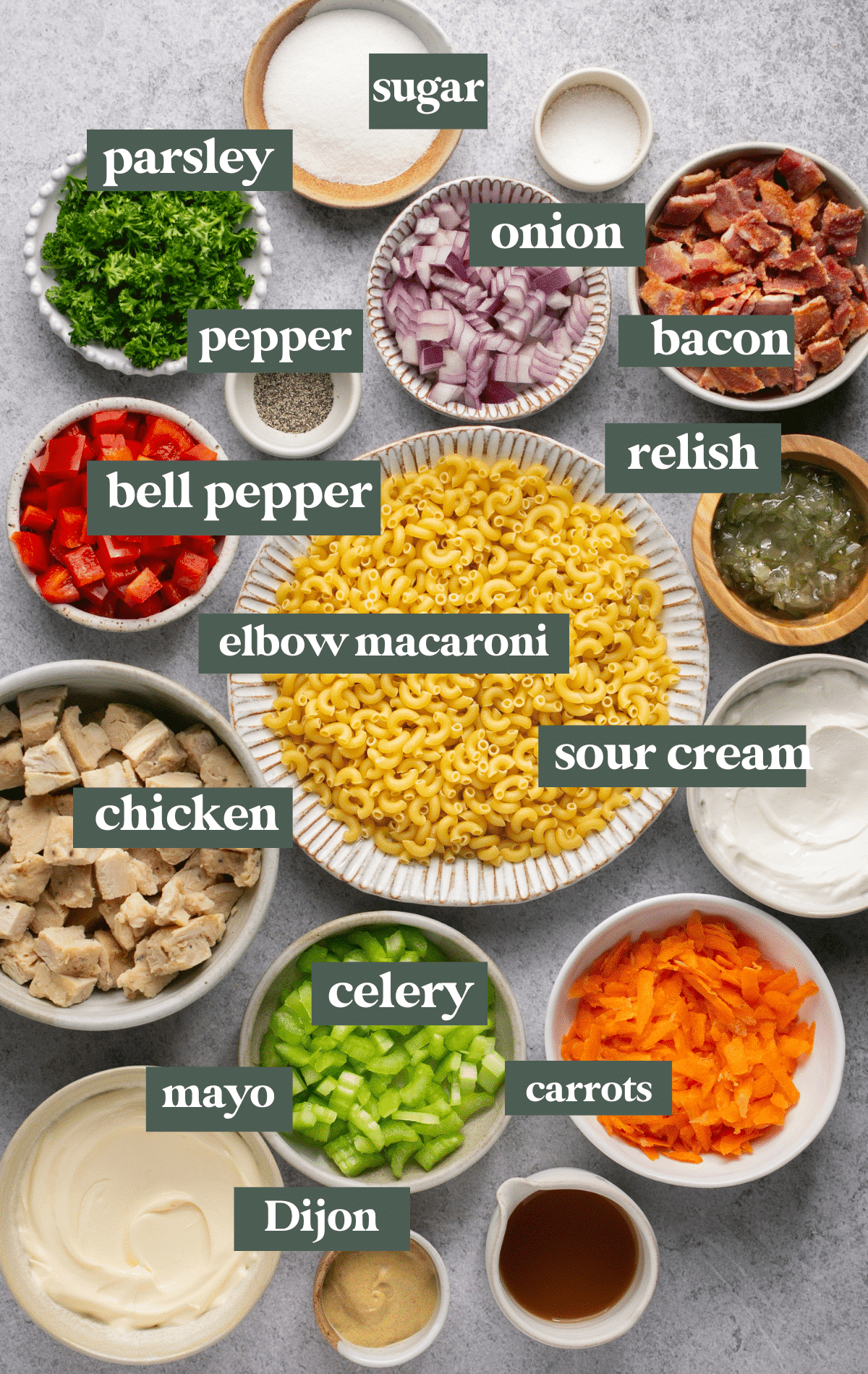 ingredients in small glass bowls to make a macaroni salad.