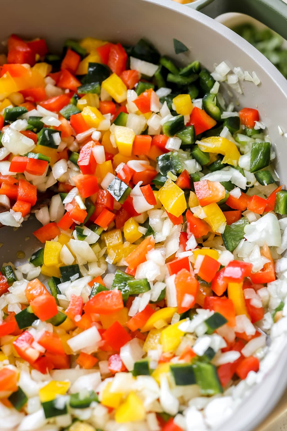 bell peppers and onions in a skillet.