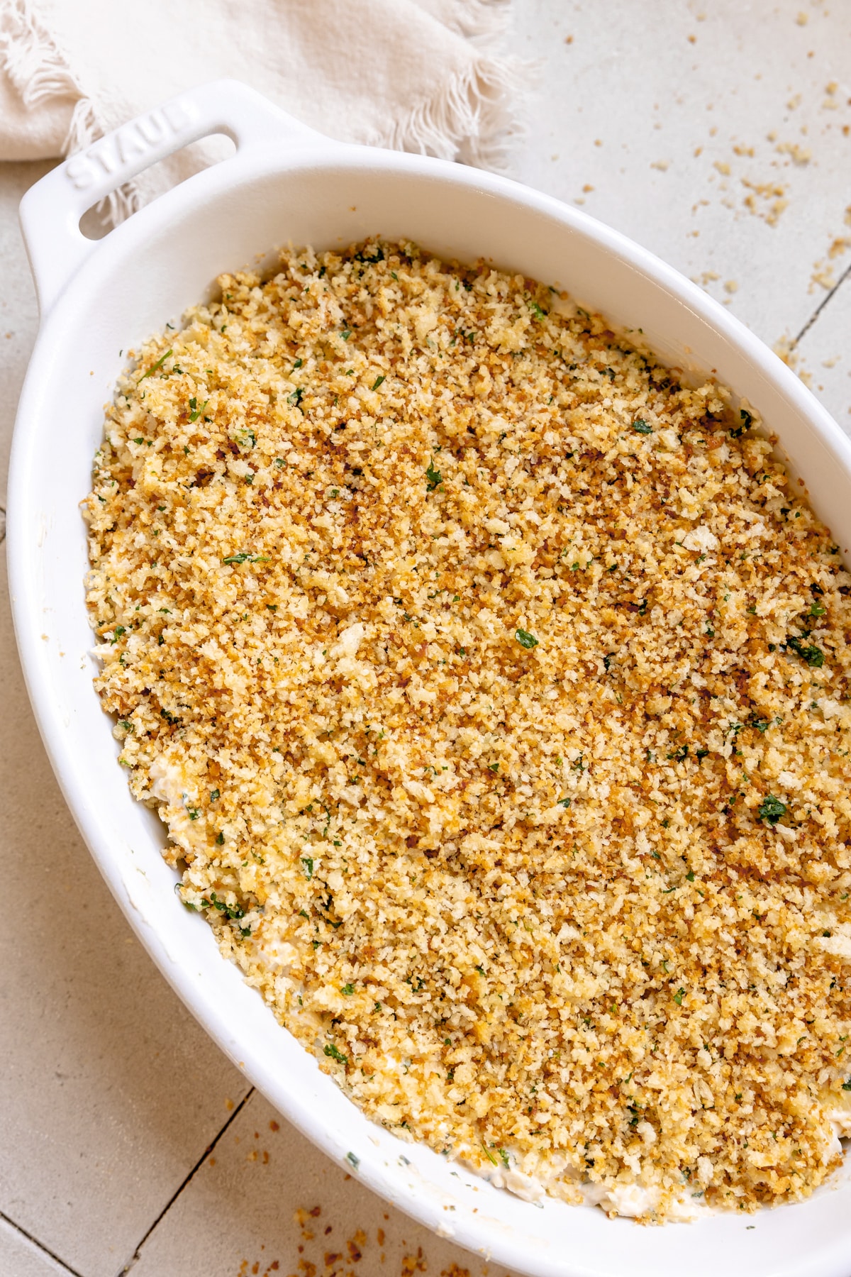 spinach artichoke dip in a casserole dihs. 