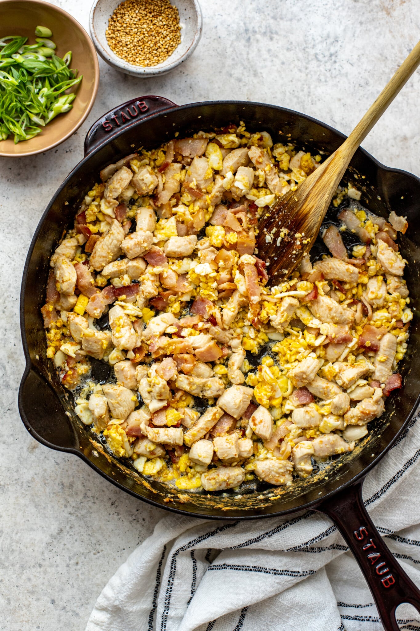 eggs, bacon and chicken in a cast iron pan.