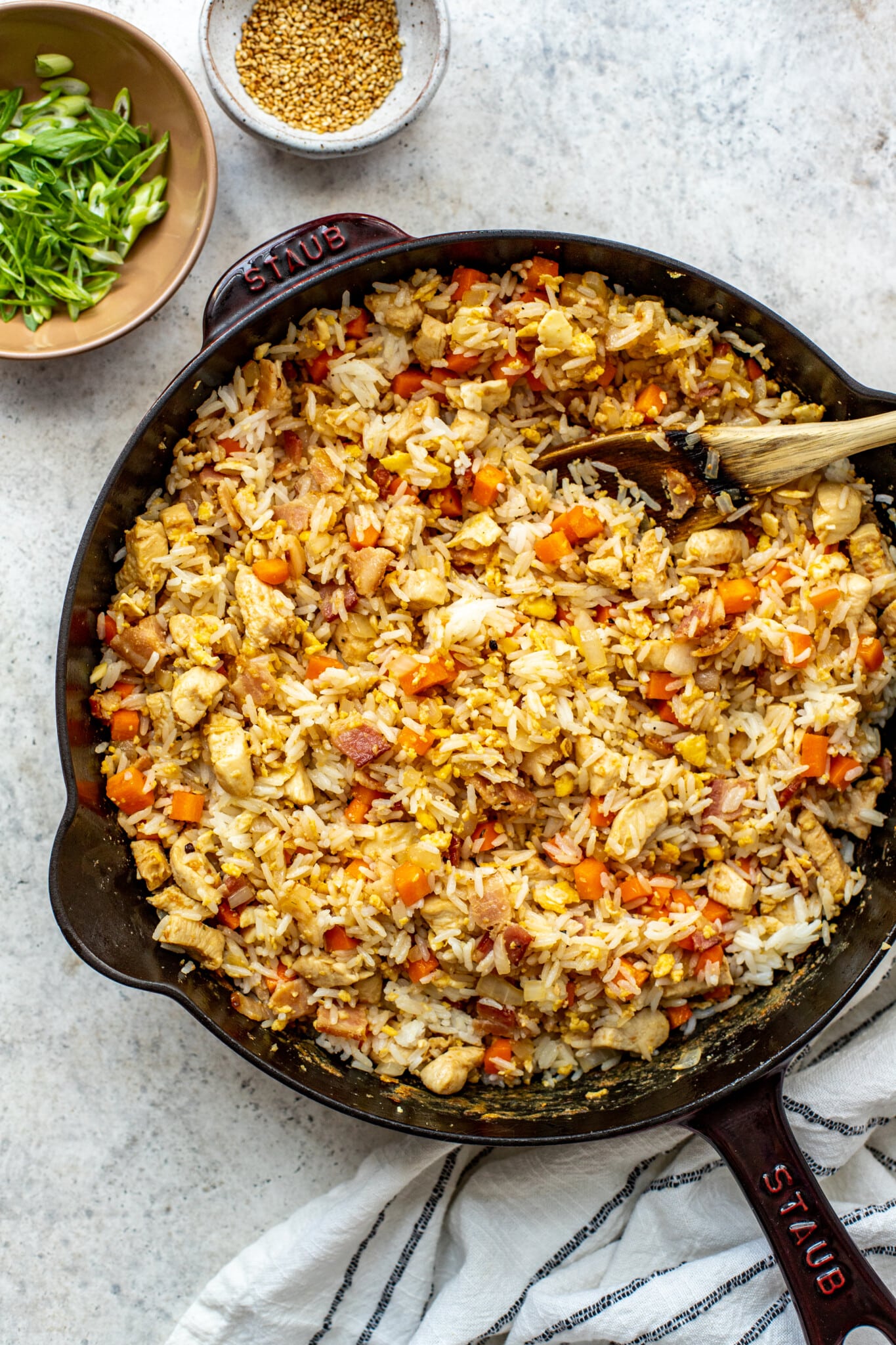 carrots and onions in a cast iron pan with chicken, bacon and scrambled eggs. 